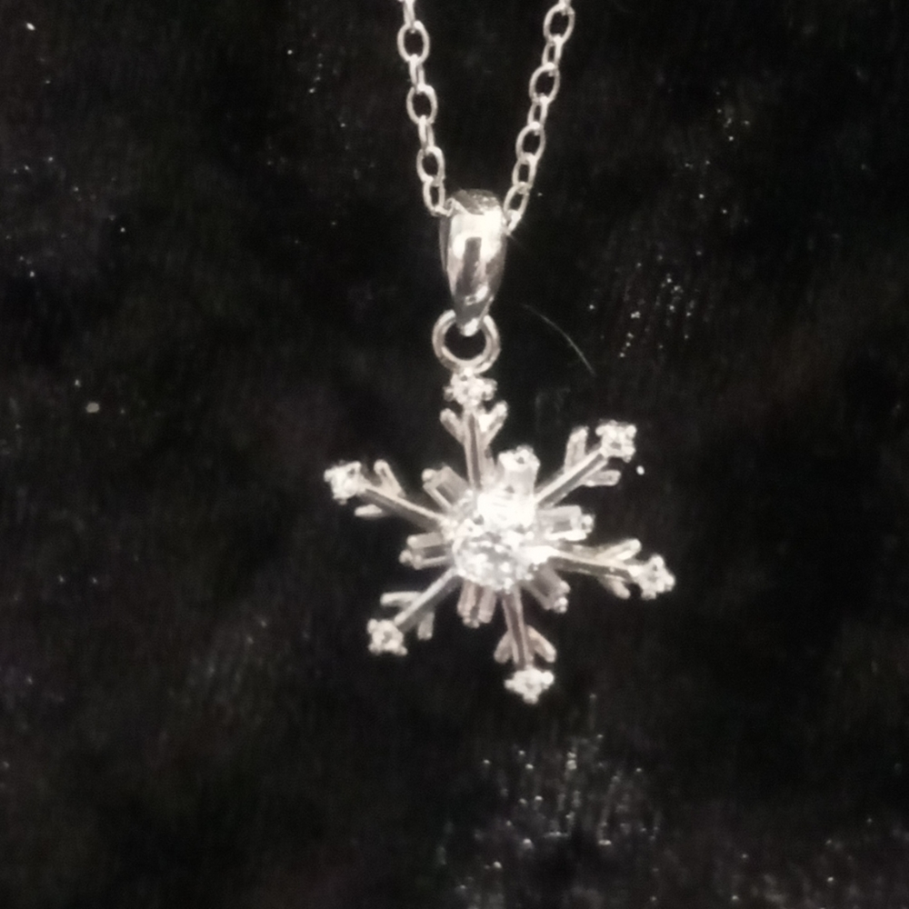 Polished CZ snowflake pendant In 925 sterling silver. 20 inches